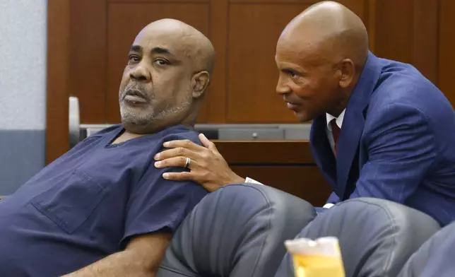 Duane "Keffe D" Davis, left, who is accused of orchestrating the 1996 slaying of hip-hop icon Tupac Shakur, listens to his attorney Carl Arnold during a hearing to reconsider his bond at the Regional Justice Center, on Tuesday, July. 23, 2024, in Las Vegas. (Bizuayehu Tesfaye/Las Vegas Review-Journal via AP)