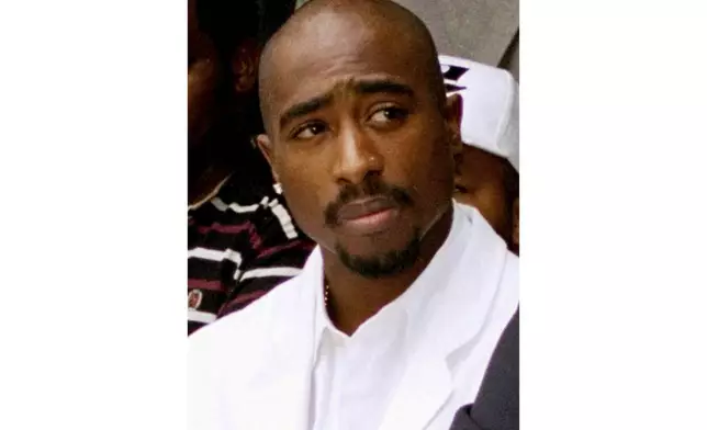 FILE - Rapper Tupac Shakur attends a voter registration event in South Central Los Angeles, Aug. 15, 1996. An ailing and aging former Los Angeles-area gang leader is due to ask a Nevada judge on Tuesday, July 23, 2024, to change her mind and release him from jail to house arrest ahead of his trial in the 1996 killing of music legend Tupac Shakur. (AP Photo/Frank Wiese, File)