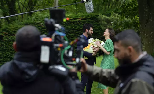 A production team is filming scenes of a Turkish drama with actor Paris Baktas and actress Yagmur Yuksel, Turkey, Tuesday, April 30, 2024. Turkey has emerged as a leading exporter of television drama, bolstering the nation’s international image and drawing millions of viewers and tourists worldwide to its historical and cultural sites which are backdrops to many of the shows. (AP Photo/Khalil Hamra)