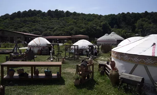 Tourists make a tour in Bozdag's outdoor film studio in Istanbul, Turkey, Wednesday, June 12, 2024. (AP Photo/Khalil Hamra)