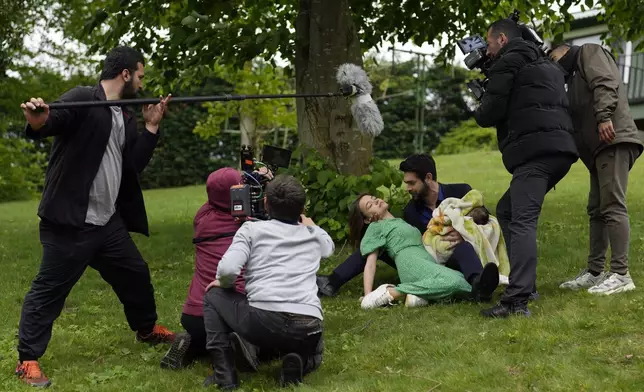 A production team is filming scenes of a Turkish drama with actor Paris Baktas and actress Yagmur Yuksel, Turkey, Tuesday, April 30, 2024. (AP Photo/Khalil Hamra)