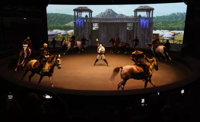 People present a horse riding performance for tourists during their visit in Bozdag's outdoor film studio in Istanbul, Turkey, Wednesday, June 12, 2024. (AP Photo/Khalil Hamra)