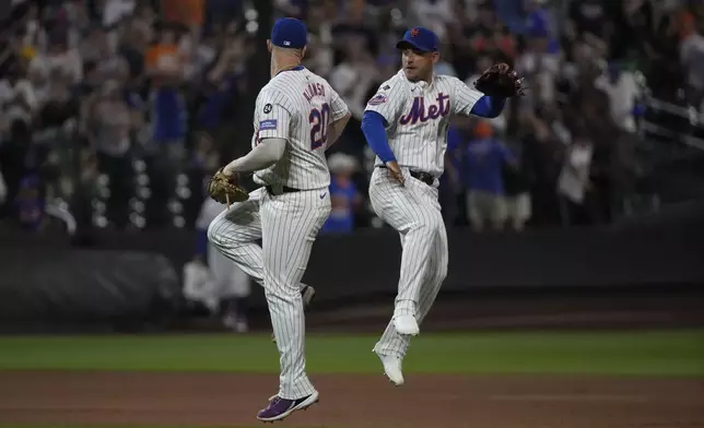 New York Mets' Pete Alonso, left, and Jose Iglesias, right, celebrate winning a baseball game against the Minnesota Twins, Tuesday, July 30, 2024, in New York. (AP Photo/Pamela Smith)