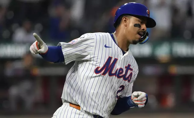 New York Mets' Mark Vientos celebrates hitting a home run during the fifth inning of a baseball game against the Minnesota Twins, Tuesday, July 30, 2024, in New York. (AP Photo/Pamela Smith)