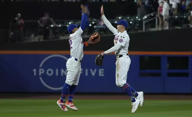 New York Mets' Francisco Lindor, left, and Brandon Nimmo, right, celebrate winning a baseball game against the Minnesota Twins, Tuesday, July 30, 2024, in New York. (AP Photo/Pamela Smith)