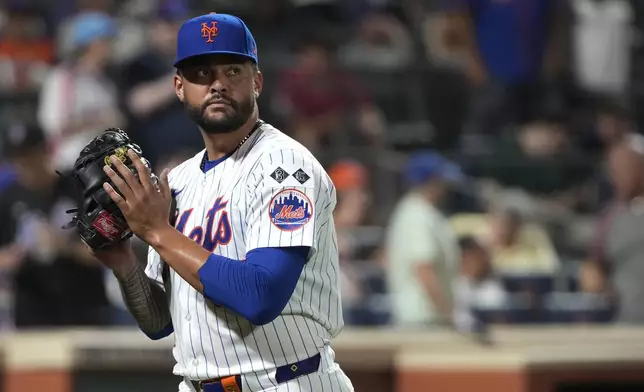 New York Mets pitcher Sean Manaea reacts as he walks to the dugout after striking out Minnesota Twins' Willi Castro during the seventh inning of a baseball game, Tuesday, July 30, 2024, in New York. (AP Photo/Pamela Smith)