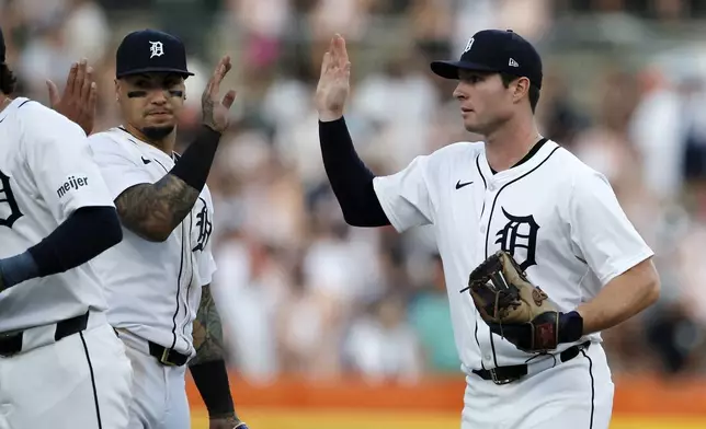 Detroit Tigers' Javier Baez (28) celebrates with Colt Keith after a 7-2 win over the Minnesota Twins in a baseball game, Saturday, July 27, 2024, in Detroit. (AP Photo/Duane Burleson)