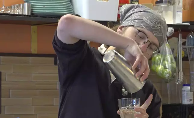 In this image taken from video shows Adam Buker pouring water in to a glass at the Canary Coffee Bar, Thursday, July 18, 2024, in Milwaukee, Wis. This week's Republican National Convention didn't deliver an overwhelming victory to some small businesses in downtown Milwaukee. There had been earlier promises of an economic boost, but some bars, convenience stores and restaurants along the edge of the secure zone sat largely empty all week. (AP Photo/Patrick Orsagos)