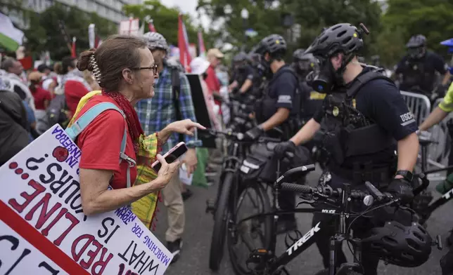 United States Capitol Police stand near protestors, Wednesday, July 24, 2024, in Washington, during of a scheduled visit by Israeli Prime Minister Benjamin Netanyahu at the U.S. Capitol. (AP Photo/Mike Stewart)