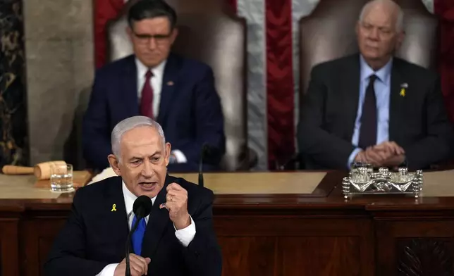 Israeli Prime Minister Benjamin Netanyahu speaks to a joint meeting of Congress at the Capitol in Washington, Wednesday, July 24, 2024, as House Speaker Mike Johnson of La., and Senate Foreign Relations Chair Ben Cardin, D-Md., listen. (AP Photo/Julia Nikhinson)