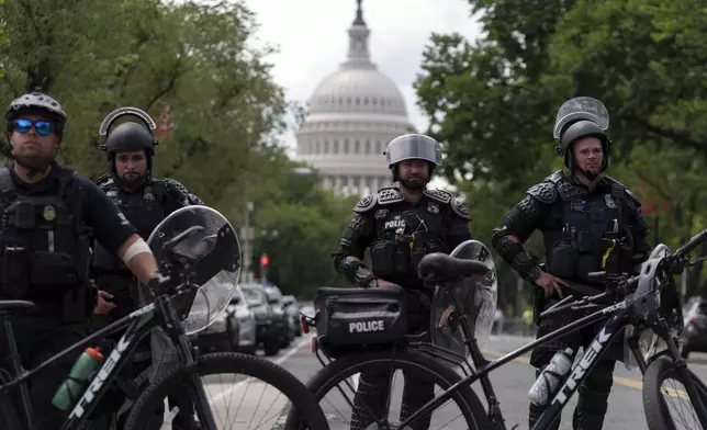 U.S. Capitol police watch demonstrators marching outside of the U.S. Capitol as they protest the visit of Israeli Prime Minister Benjamin Netanyahu on Capitol Hill, Wednesday, July 24, 2024, in Washington. (AP Photo/Jose Luis Magana)