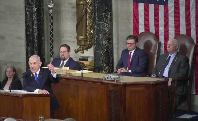 Israeli Prime Minister Benjamin Netanyahu speaks to a joint meeting of Congress at the Capitol in Washington, Wednesday, July 24, 2024, as House Speaker Mike Johnson of La., and Senate Foreign Relations Chair Ben Cardin, D-Md., watch. (AP Photo/Manuel Balce Ceneta)