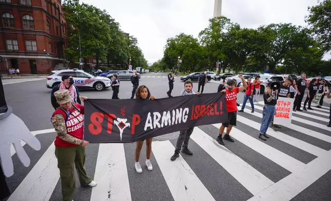 Demonstrators blocking traffic on Independence Ave., near the National Mall ahead of a scheduled visit by Israeli Prime Minister Benjamin Netanyahu to the US Capitol, Wednesday, July 24, 2024, in Washington. (AP Photo/Matt Slocum)