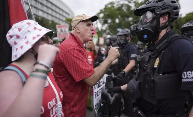 United States Capitol Police stand near protestors, Wednesday, July 24, 2024, in Washington, during of a scheduled visit by Israeli Prime Minister Benjamin Netanyahu at the U.S. Capitol. (AP Photo/Mike Stewart)