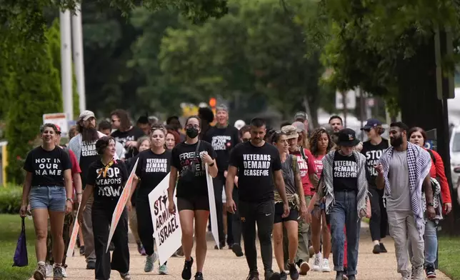 Protestors walk, Wednesday, July 24, 2024, in Washington, ahead of a scheduled visit by Israeli Prime Minister Benjamin Netanyahu at the U.S. Capitol. (AP Photo/Mike Stewart)