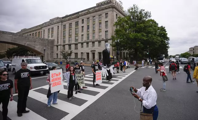 Demonstrators blocking traffic on Independence Ave., near the National Mall ahead of a scheduled visit by Israeli Prime Minister Benjamin Netanyahu to the US Capitol, Wednesday, July 24, 2024, in Washington. (AP Photo/Matt Slocum)