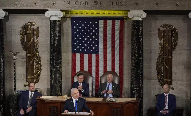 Israeli Prime Minister Benjamin Netanyahu speaks to a joint meeting of Congress at the Capitol in Washington, Wednesday, July 24, 2024, as House Speaker Mike Johnson of La., and Senate Foreign Relations Chair Ben Cardin, D-Md., listen. (AP Photo/Julia Nikhinson)