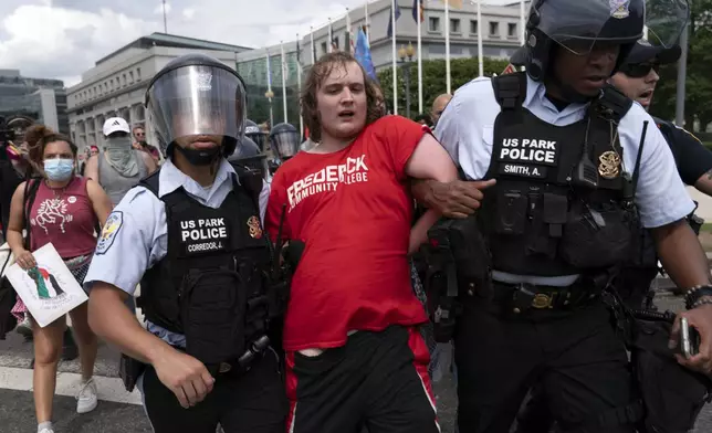 A demonstrator is taken into custody as they protest the visit of Israeli Prime Minister Benjamin Netanyahu on Capitol Hill, Wednesday, July 24, 2024, in Washington. (AP Photo/Jose Luis Magana)