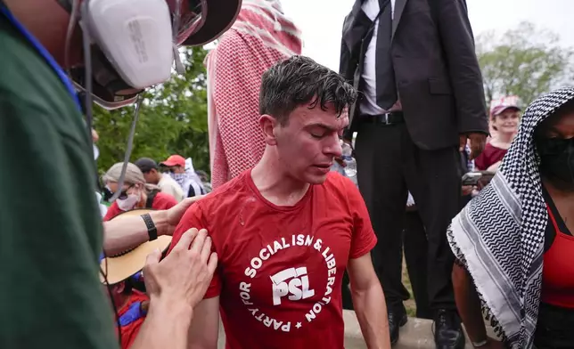 First aid is administered to a demonstrator at a protest near the Capitol during Israeli Prime Minister Benjamin Netanyahu's visit on Wednesday, July 24, 2024, in Washington. (AP Photo/Matt Slocum)