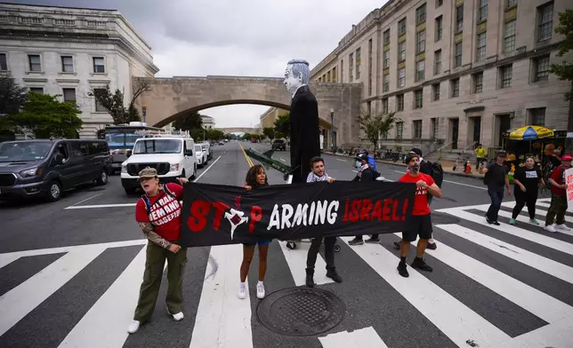 Demonstrators blocking traffic on Independence Ave., near the National Mall ahead of a scheduled visit by Israeli Prime Minister Benjamin Netanyahu to the US Capitol, Wednesday, July 24, 2024, in Washington. (AP Photo/Matt Slocum)