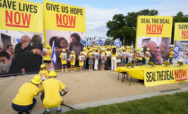 A group calling themselves Seal the Deal gathering during an event on the National Mall near the US Capitol on Tuesday, July 23, 2024, in Washington. A group of released hostages and family members of Israeli hostages held a press conference ahead of Israeli Prime Minister Benjamin Netanyahu's address to Congress on Wednesday. (AP Photo/Mike Stewart)