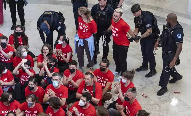 U.S. Capitol Police detain demonstrators protesting against the military policies of Israel a day before a visit by Israeli Prime Minister Netanyahu who will address a joint meeting of Congress on Wednesday, in the Cannon House Office Building at the Capitol in Washington, Tuesday, July 23, 2024. (AP Photo/J. Scott Applewhite)