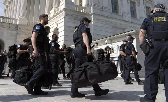 U.S Capitol police officers walk into the Capitol building a day before of Israel's Prime Minister Benjamin Netanyahu visit to Capitol Hill, Tuesday, July 23, 2024, in Washington. ( AP Photo/Jose Luis Magana)