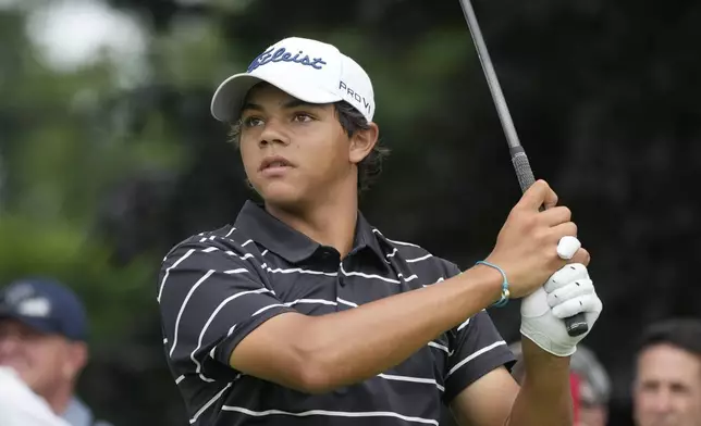 Charlie Woods drives off the 18th tee during the first round of stroke play of the U.S. Junior Amateur Golf Championship, Monday, July 22, 2024, in Bloomfield Township, Mich. (AP Photo/Carlos Osorio)