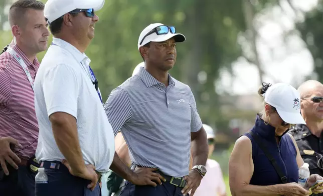 Tiger Woods watches his son Charlie Woods play during the first round of stroke play of the U.S. Junior Amateur Golf Championship, Monday, July 22, 2024, in Bloomfield Township, Mich. (AP Photo/Carlos Osorio)