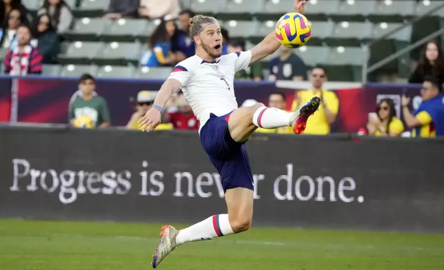 FILE - United States' Walker Zimmerman reaches for the ball on a cross during the first half of an international friendly soccer match against Colombia Saturday, Jan. 28, 2023, in Carson, Calif. Defenders Miles Robinson and Walker Zimmerman along with forward Djordje Mihailovic will be the three overage players on the 18-man U.S. Olympic men’s soccer roster after failing to get used by the senior national team at the Copa America. Olympic soccer is limited to players under 23, with each team allowed three over the age limit. (AP Photo/Marcio Jose Sanchez, File)