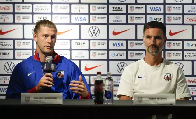 Marko Mitrovic, right, head coach of the United States men's olympics soccer team, listens as defender Walker Zimmerman talks during a news conference in New York, Monday, July 8, 2024. (AP Photo/Seth Wenig)