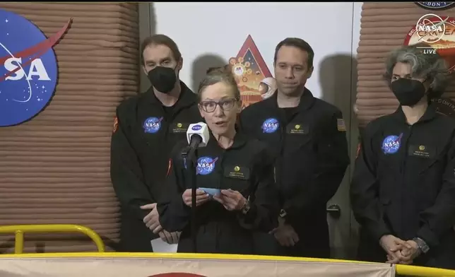 In this image made from video provided by NASA, Kelly Haston, a crew member of the first CHAPEA mission, speaks in front of other members, from left to right, Ross Brockwell, Nathan Jones, and Anca Selariu, Saturday, July 6, 2024, at Johnson Space Center in Houston, Texas. The crew of a NASA mission to Mars emerged from their craft after a yearlong voyage that never left Earth. The four volunteers crew members spent more than 12 months inside NASA's first simulated Mars environment at Johnson Space Center in Houston, coming out of the artificial alien environment Saturday. (NASA via AP)