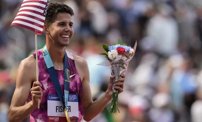 Grant Fisher celebrates winning the men's 5000-meter final run during the U.S. Track and Field Olympic Team Trials, Sunday, June 30, 2024, in Eugene, Ore. (AP Photo/George Walker IV)