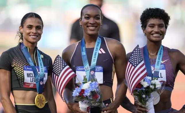 First place winner Sydney McLaughlin-Levrone, left, second place Anna Cockrell, right, and third place Jasmine Jones pose fopr a photo after the women's 400-meter hurdles final during the U.S. Track and Field Olympic Team Trials, Sunday, June 30, 2024, in Eugene, Ore.(AP Photo/Charlie Neibergall)