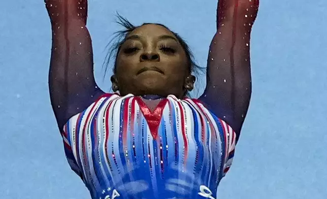 Simone Biles competes on the uneven bars at the United States Gymnastics Olympic Trials on Sunday, June 30, 2024, in Minneapolis. (AP Photo/Charlie Riedel)