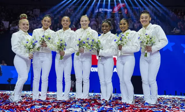 From left to right, Joscelyn Roberson, Suni Lee, Hezly Rivera, Jade Carey, Simone Biles, Jordan Chiles and Leanne Wong smile after they were named to the 2024 Olympic team at the United States Gymnastics Olympic Trials on Sunday, June 30, 2024, in Minneapolis. (AP Photo/Charlie Riedel)