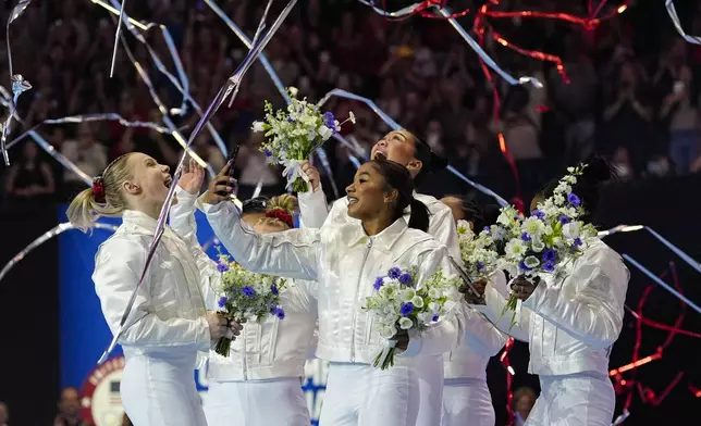 The women celebrate as the 2024 team is named for the Paris Olympics at the United States Gymnastics Olympic Trials on Sunday, June 30, 2024, in Minneapolis. (AP Photo/Abbie Parr)