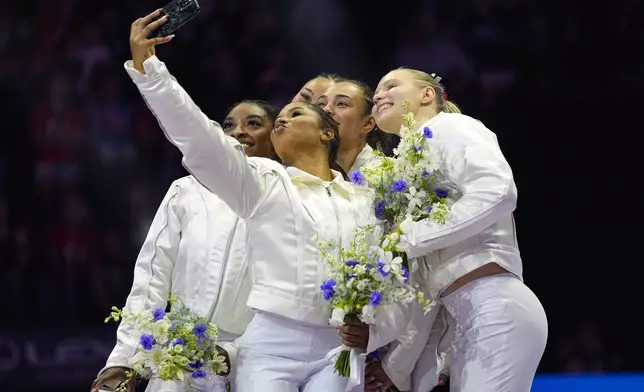 Jordan Chiles takes a selfie with the team after the women were named to the 2024 Olympic team at the United States Gymnastics Olympic Trials on Sunday, June 30, 2024, in Minneapolis. (AP Photo/Abbie Parr)
