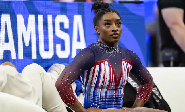 Simone Biles reacts after her balance beam performance at the United States Gymnastics Olympic Trials on Sunday, June 30, 2024, in Minneapolis. (AP Photo/Abbie Parr)