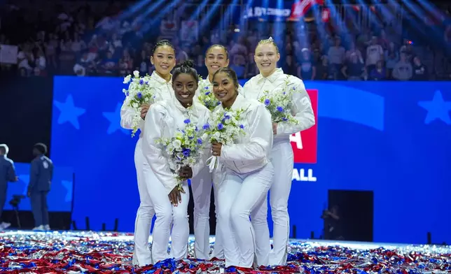 The U.S. women's team from left to right, Suni Lee, Simone Biles, Hezly Rivera, Jordan Chiles and Jade Carey, smile after being named to the 2024 Olympic team at the United States Gymnastics Olympic Trials on Sunday, June 30, 2024, in Minneapolis. (AP Photo/Charlie Riedel)