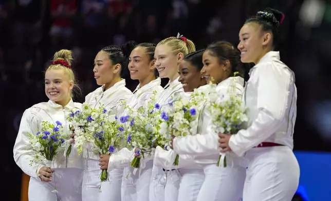 From left to right, Joscelyn Roberson, Suni Lee, Hezly Rivera, Jade Carey, Simone Biles, Jordan Chiles and Leanne Wong smiles after they were named to the 2024 Olympic team at the United States Gymnastics Olympic Trials on Sunday, June 30, 2024, in Minneapolis. (AP Photo/Abbie Parr)