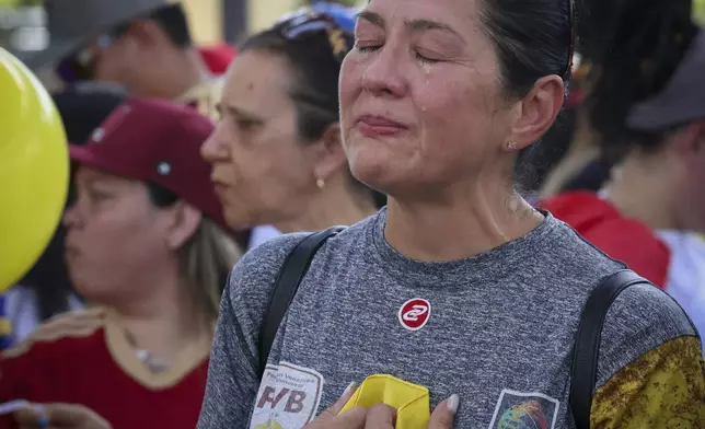 Silviana Lazaro cries while a Venezuelan song plays at a rally at Jose Marti Gym held in support of a fair election on Venezuela's Election Day on Sunday, July 28, 2024, in Miami. (Alie Skowronski/Miami Herald via AP)