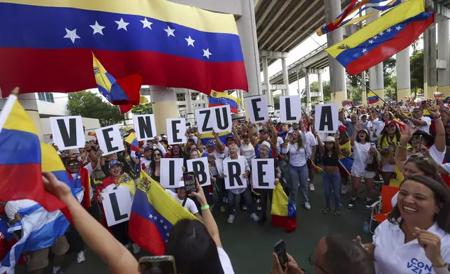 People bring signs that spell out "Venezuela Libre" during a rally at Jose Marti Gym held in support of a fair election on Venezuela's Election Day on Sunday, July 28, 2024, in Miami. (Alie Skowronski/Miami Herald via AP)