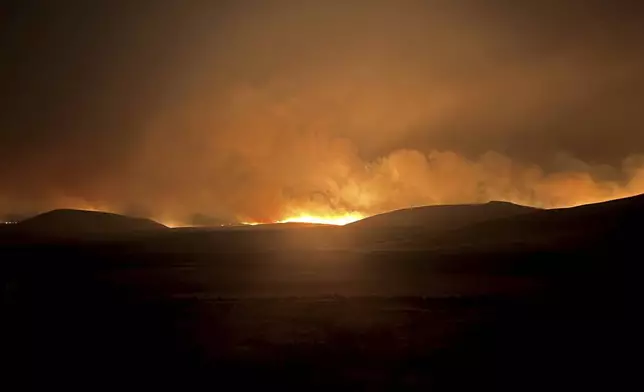 In this photo provided by the Oregon Department of Transportation, the Durkee Fire lights up the sky in eastern Ore., Monday, July 22, 2024. (Oregon Department of Transportation via AP)