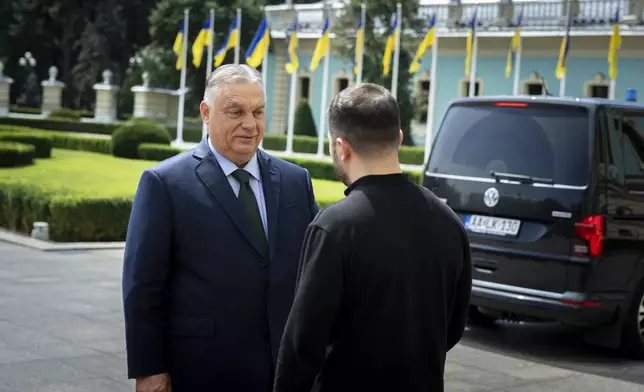 In this photo issued by the Hungarian PM's Press Office, Ukrainian President Volodymyr Zelenskyy, right, welcomes Hungarian Prime Minister Viktor Orban in Kyiv, Ukraine, Tuesday, July 2, 2024. (Zoltan Fischer/Hungarian PM's Press Office/MTI via AP)