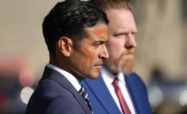 Nico LaHood left, attorney for former Uvalde Consolidated Independent School District police officer Adrian Gonzales, speaks with the media outside the Uvalde County Courthouse, Thursday, July 25, 2024, in Uvalde, Texas. (AP Photo/Eric Gay)