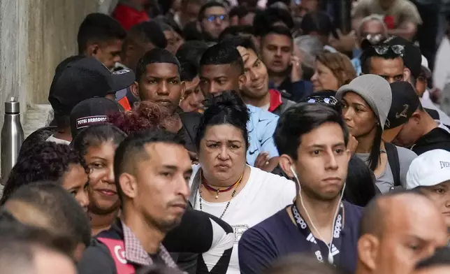 Voters line up at a polling center during presidential elections in Caracas, Venezuela, Sunday, July 28, 2024. (AP Photo/Matias Delacroix)