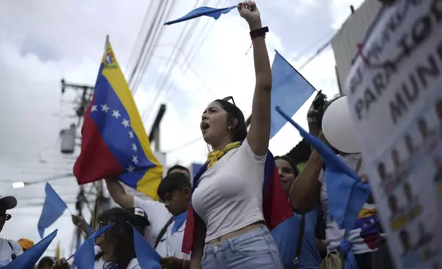 Supporters of opposition presidential candidate Edmundo Gonzalez get revved up as thousands wait for his arrival at a campaign rally in Barinas, Venezuela, Saturday, July 6, 2024. The official campaign period for the July 28 election kicked off on July 4. (AP Photo/Ariana Cubillos)