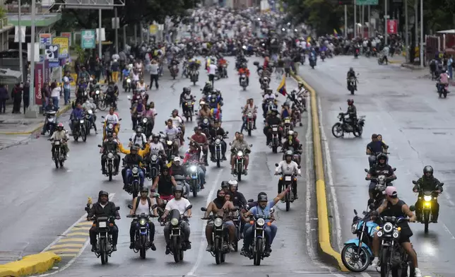 Protesters on motorcycles demonstrate against the official election results declaring President Nicolas Maduro won reelection, the day after the vote in Caracas, Venezuela, Monday, July 29, 2024. (AP Photo/Fernando Vergara)