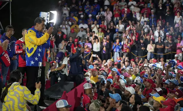 President Nicolas Maduro addresses supporters gathered outside the Miraflores presidential palace after electoral authorities declared him the winner of the presidential election in Caracas, Venezuela, Monday, July 29, 2024. (AP Photo/Fernando Vergara)